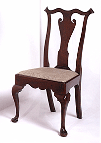 A Chippendale chair in the Queen Anne style.